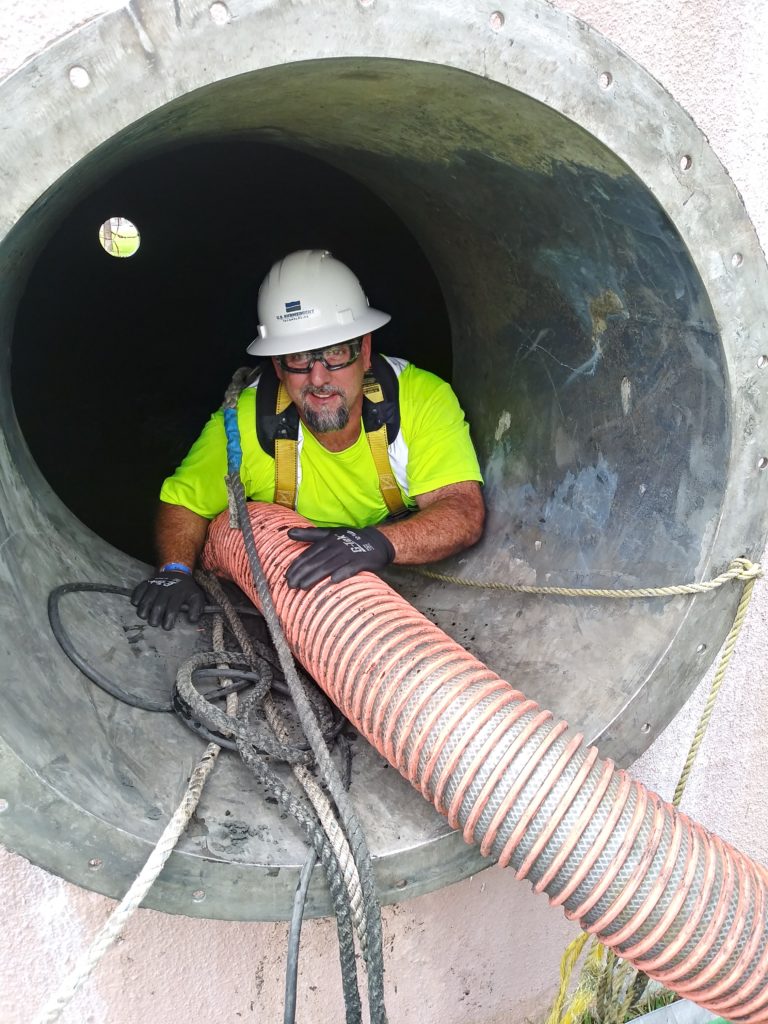 USST foreman follows the safety plan while cleaning pipe