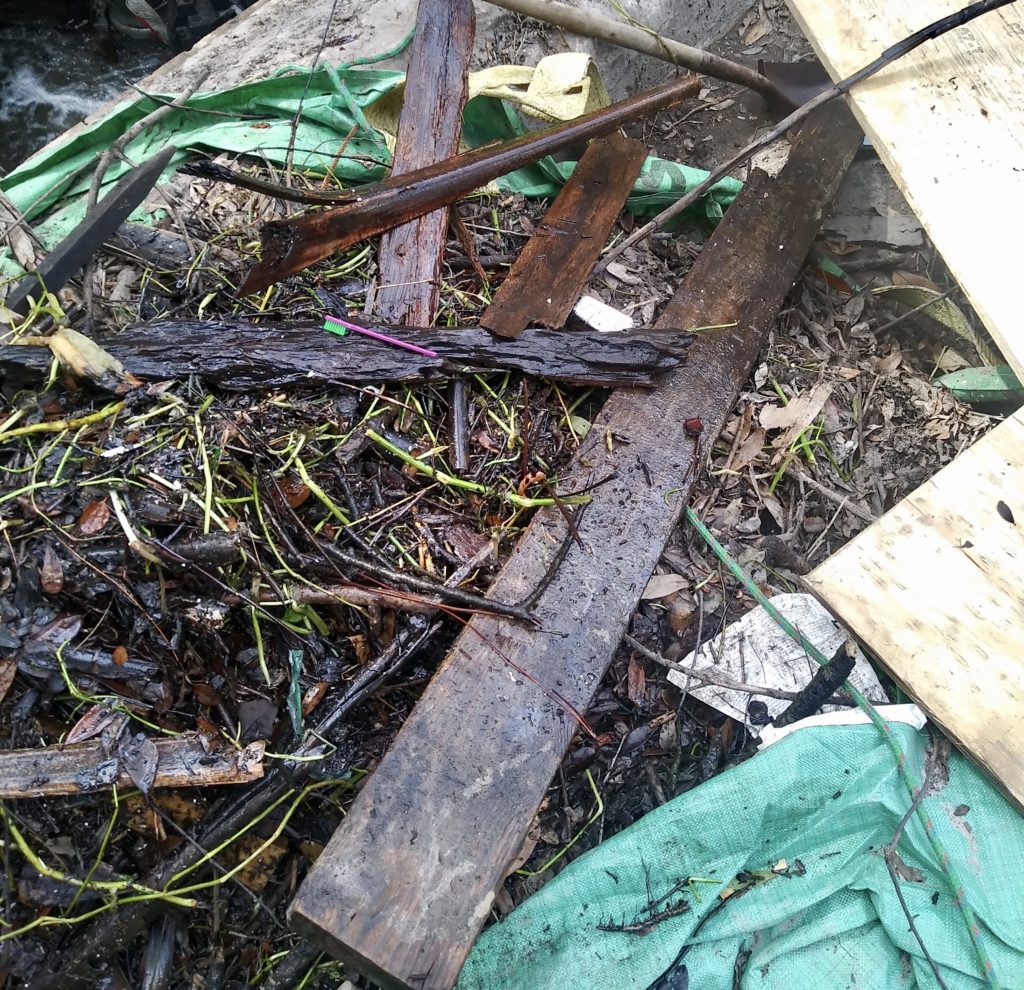 Debris, boards, and vegetation removed from a stormwater box culvert